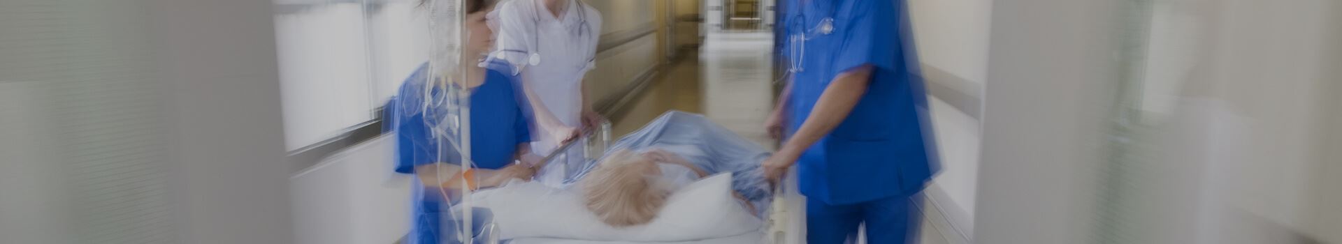 nurses pushing person on gurney