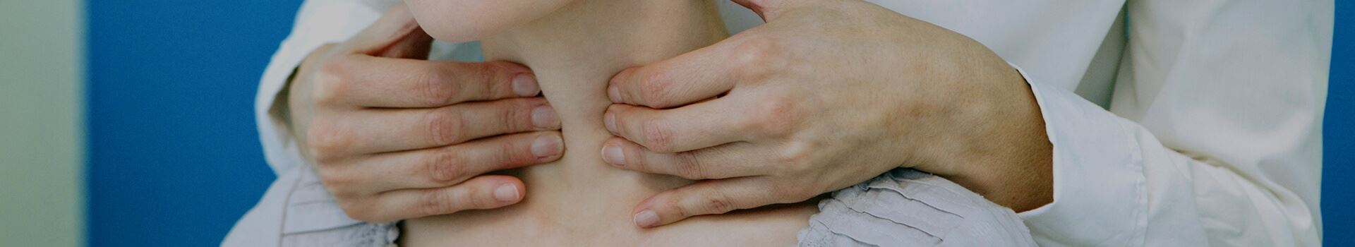 hands massaging throat and esophagus