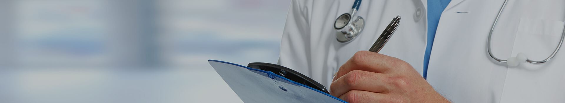 doctor writing on clipboard