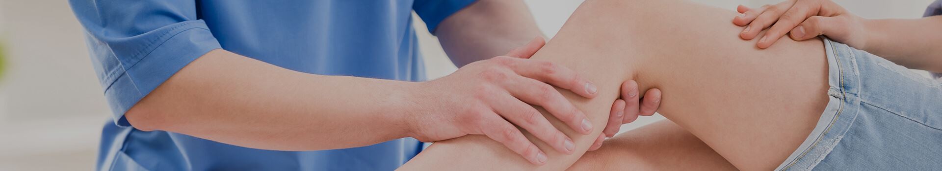 therapist massaging calf muscle