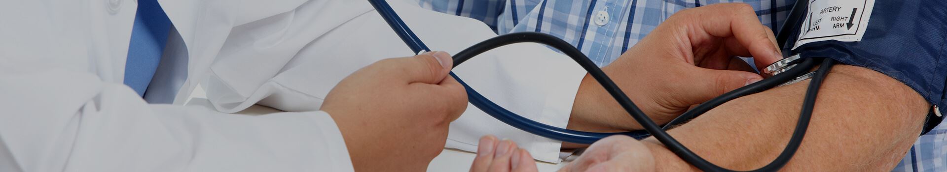 doctor taking patient's blood pressure