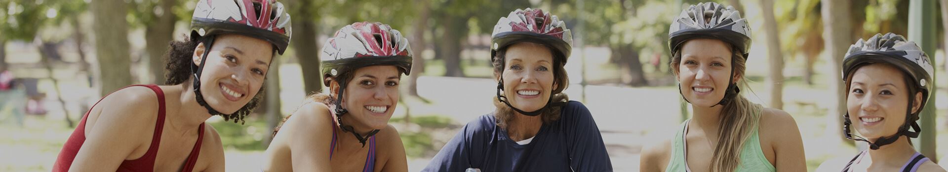 group of women with bicycle helmets on